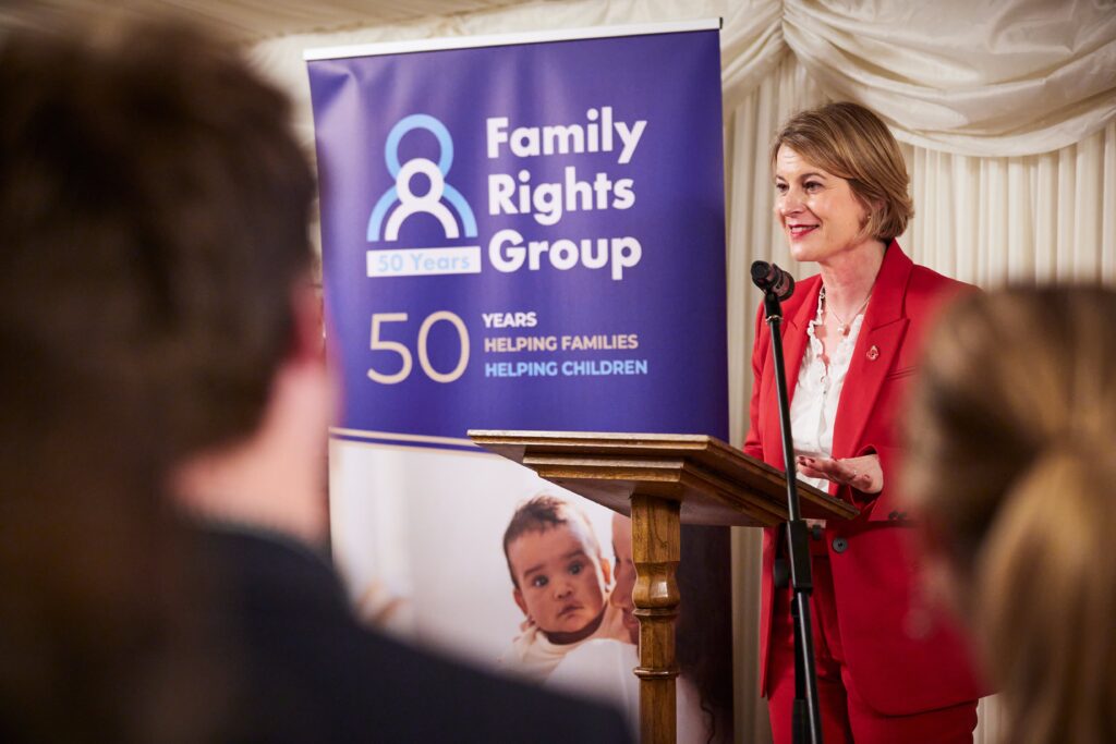Helen Hayes MP speaking in front of an Family Rights Group 50 years banner