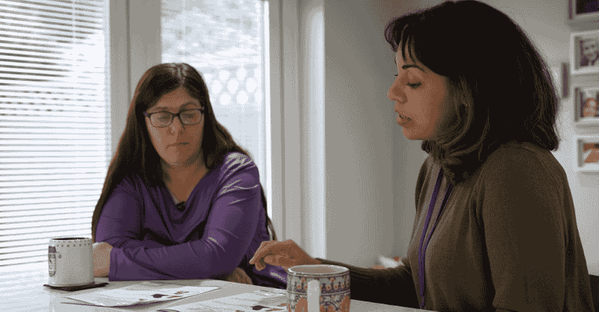 Parent with learning difficulties and disabilities talking with a social worker