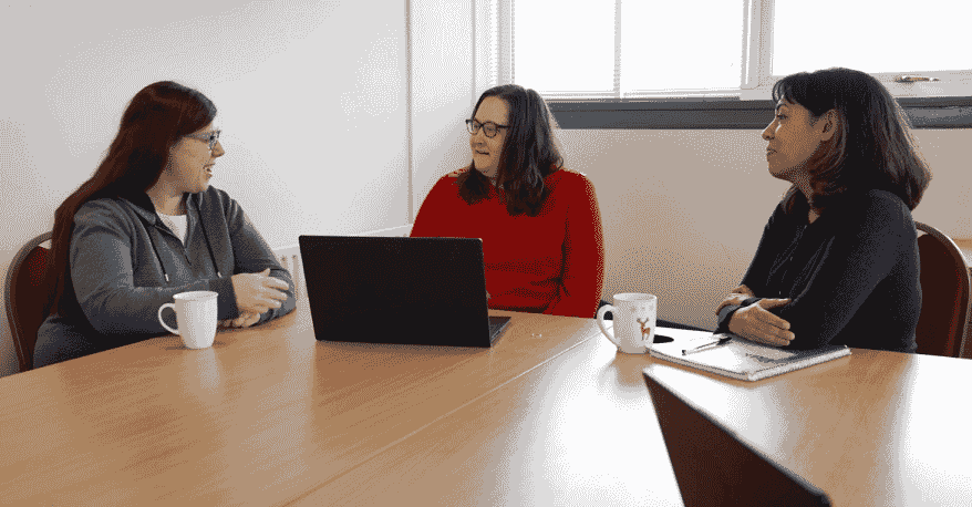 Parent with learning difficulties and disabilities talking with their advocate and a social worker